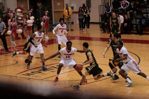 Youssoupha Kane (14) trys to stay in front of the speedy Chrishawn Hopkins (20).