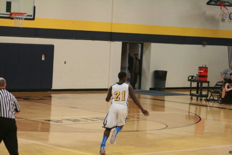 Shawn Jackson (21) of Fraser runs down court after hitting a three pointer to extend Fraser's lead.