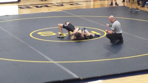 Nate Hollifield tries to pin his opponent in his first match of the evening vs L'Anse Creuse North.