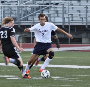 Brendan Soloman avoids number 23 as he takes the ball upfield.