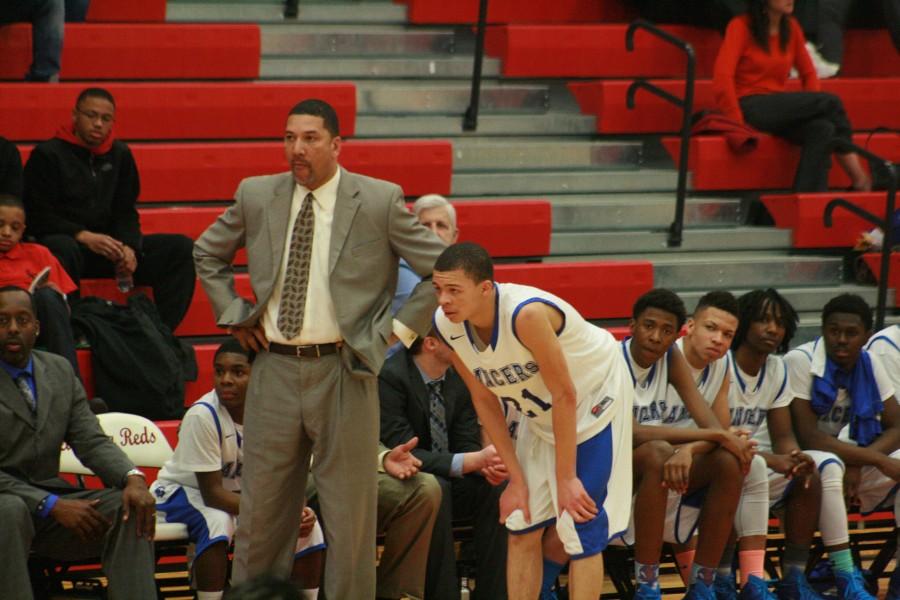 Junior Adam Samuel (21) of LAnse Creuse stands next to coach George Woods after fouling out.