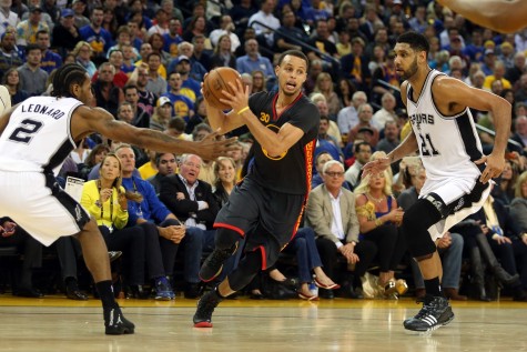 Golden State's Stephen Curry drives past San Antonio's Tim Duncan. (Ray Chavez/Bay News Area Group/TNS).