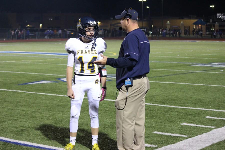 Coach Sklad and quarterback Ian Casey discussing a play during the 2nd quarter against LAnse Creuse.