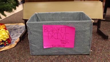 HOSA members place boxes in the media center and around school to collect blankets during the drive. 