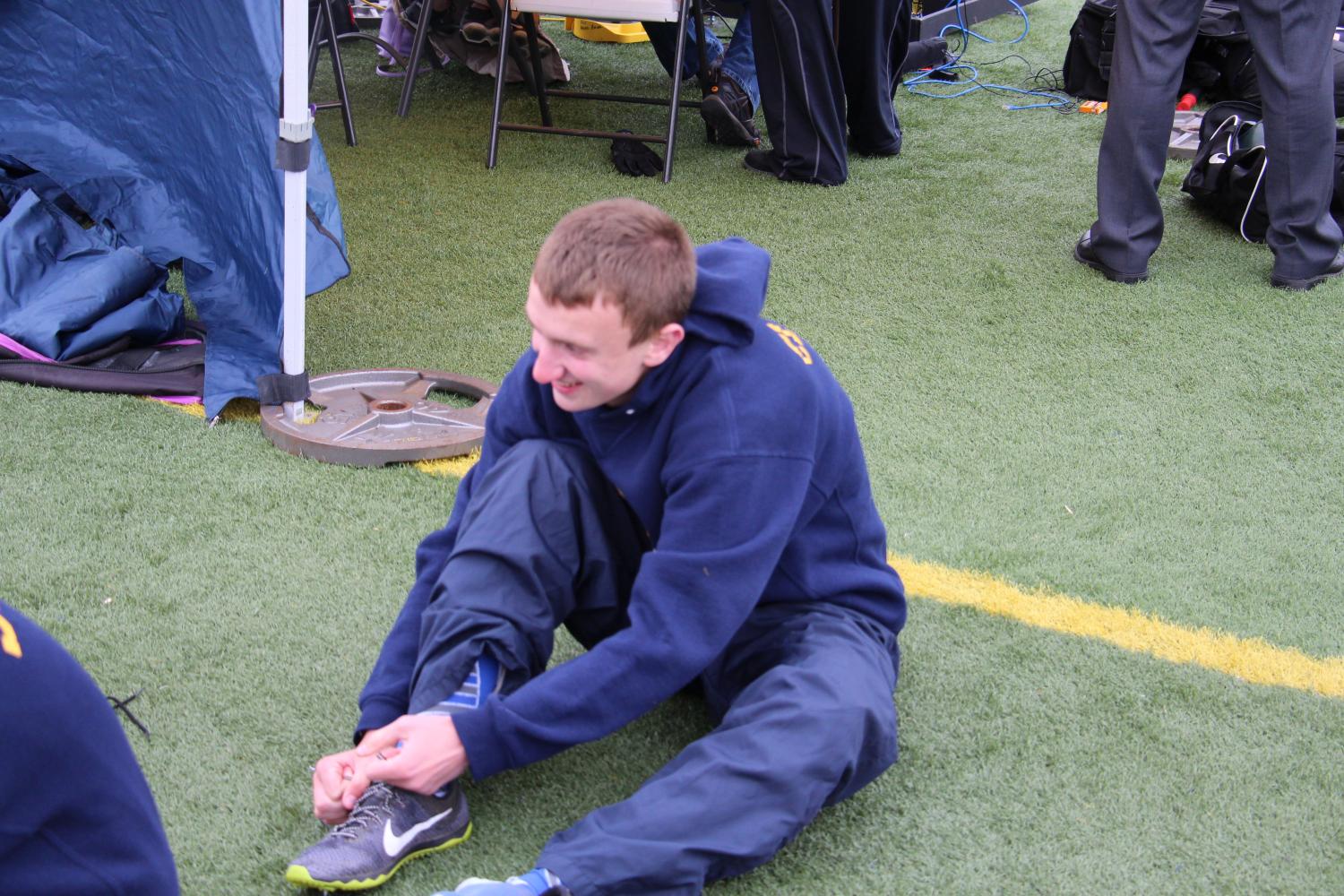 On a very cold May 2nd 2017,sophomore Benjamin Clark, unties his warm up shoes to put on his track spikes as he prepares for his event as Fraser hosts Cousino 