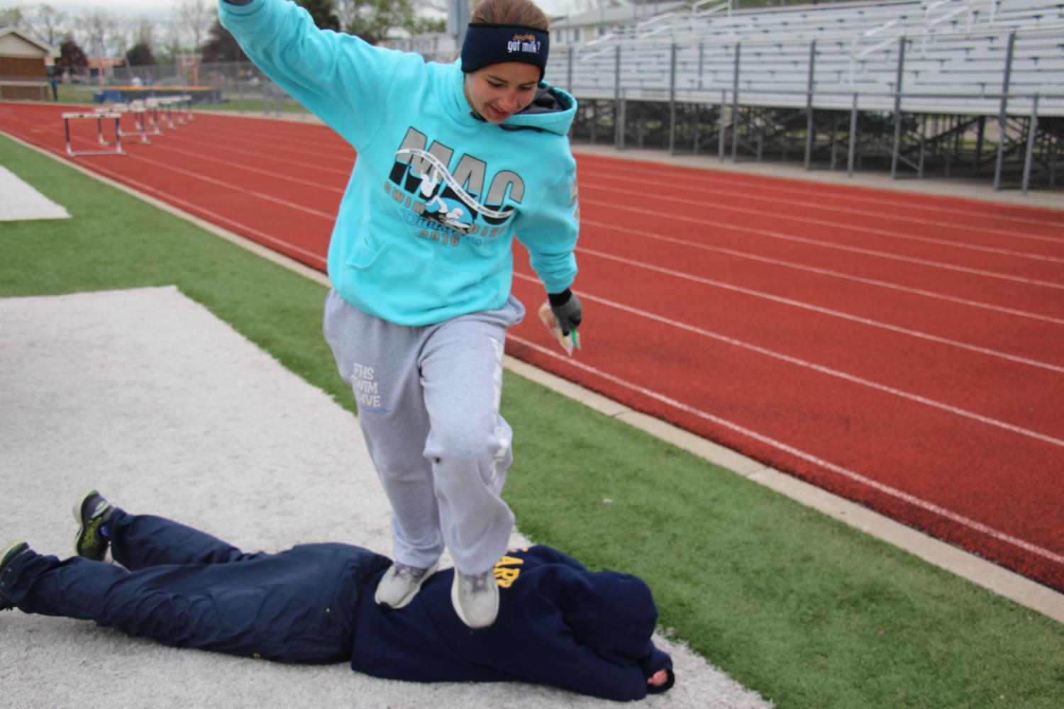 After their races, Senior Janice Chandler decides to have some fun while waiting for the next race to start by giving Ben Clark a walking back massage. 