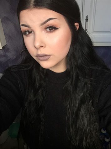Senior Casey Bresso takes a picture to show off her skills with makeup.