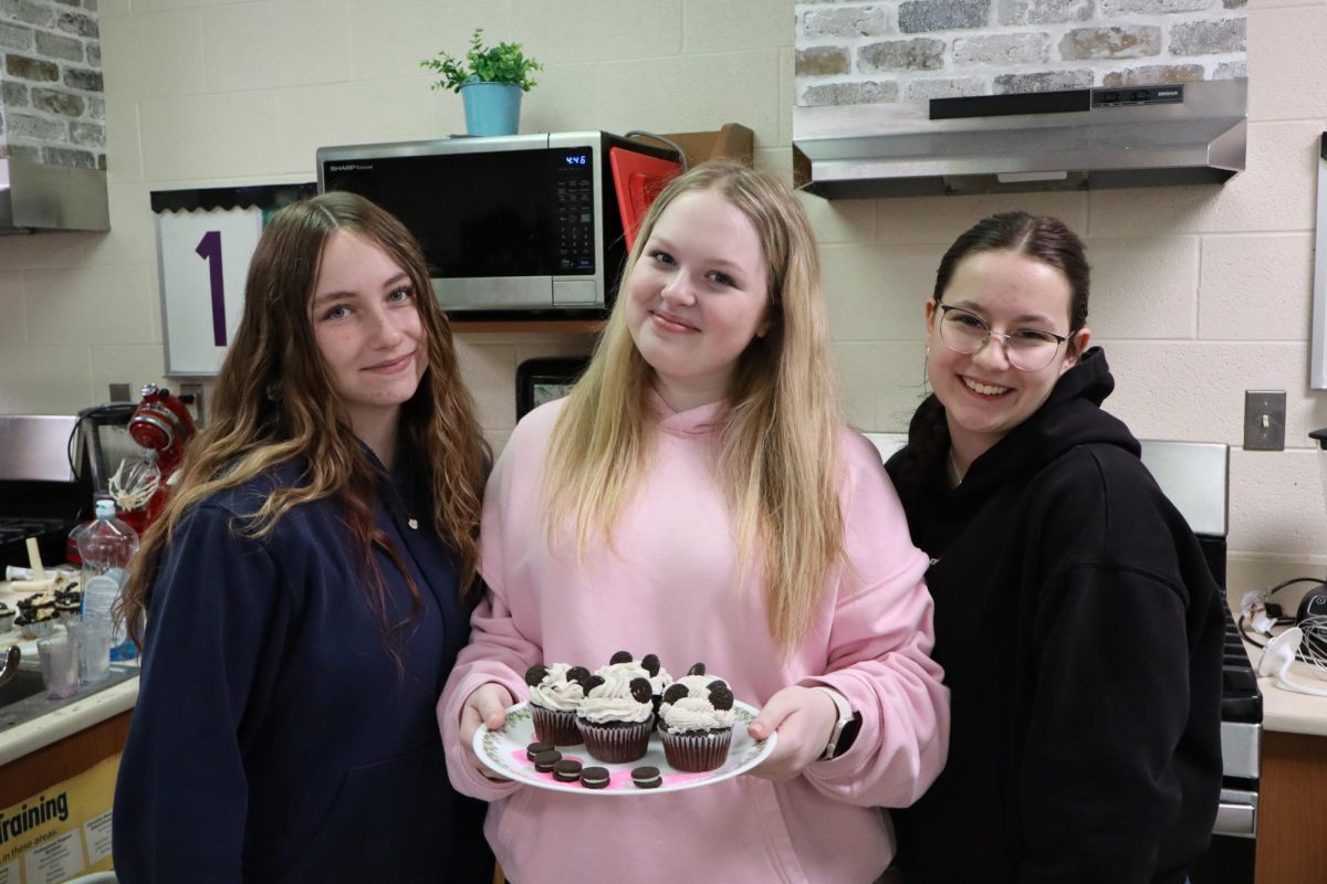 Students Frieda Quaas, Alex Smith, and Angelica Lovrd showing off their cupcakes
