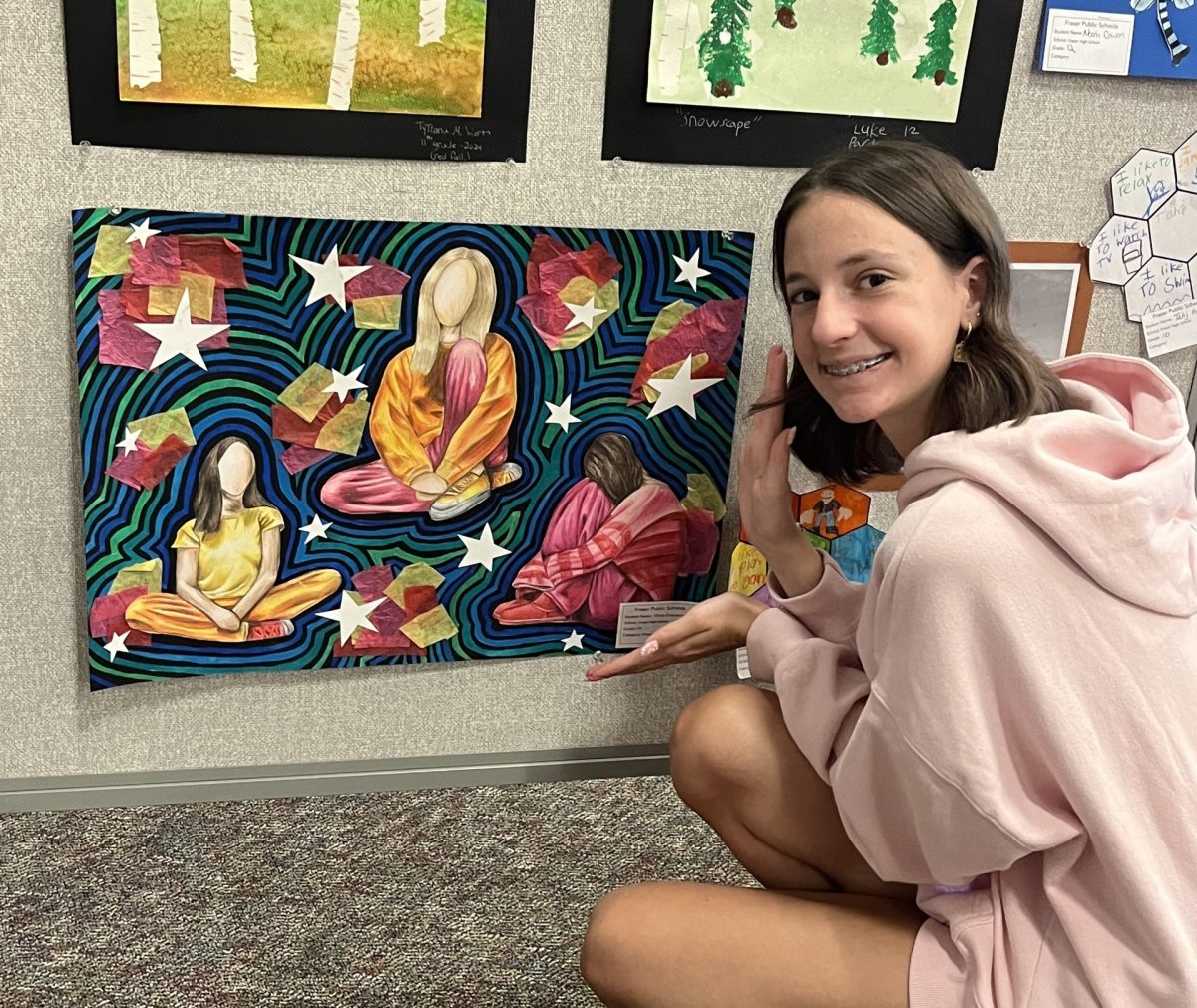 Art student Olivia Cracchiolo posing with her piece titled "Movement."